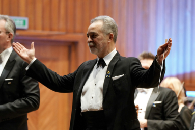 mężczyzna, dyrygent z gestem rozłożonych dłoni